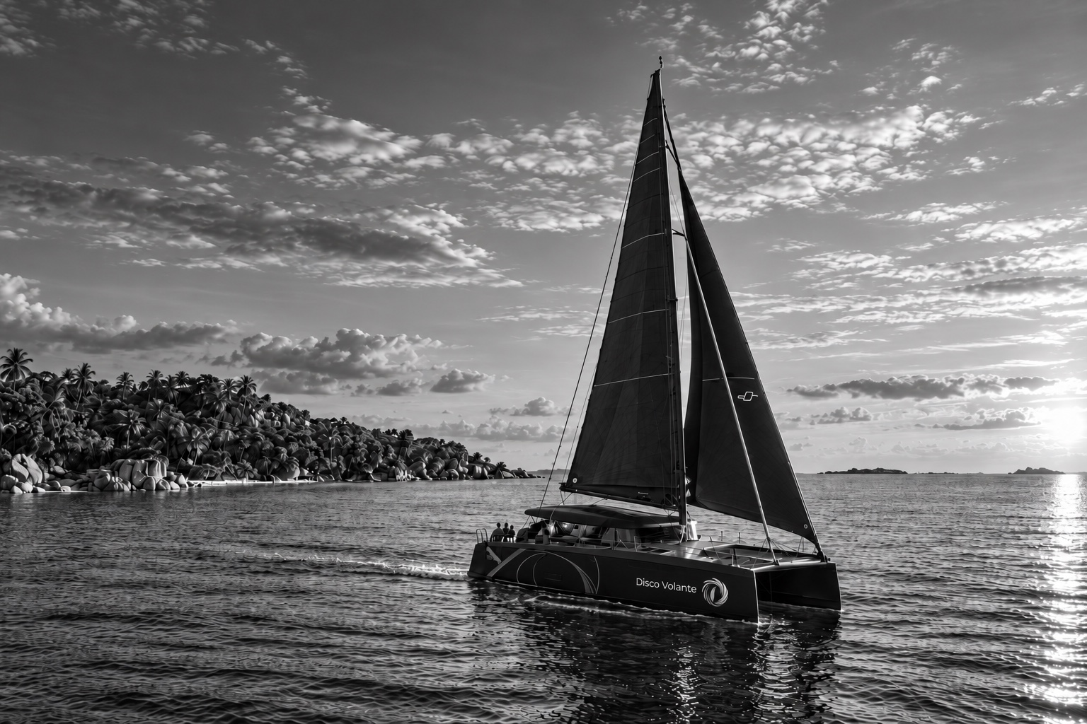 Disco Volante, an Excess 14 catamaran under black sails off a granite and palm island at dusk, in black and white. An illustration generated from the owner's photograph of the boat.
